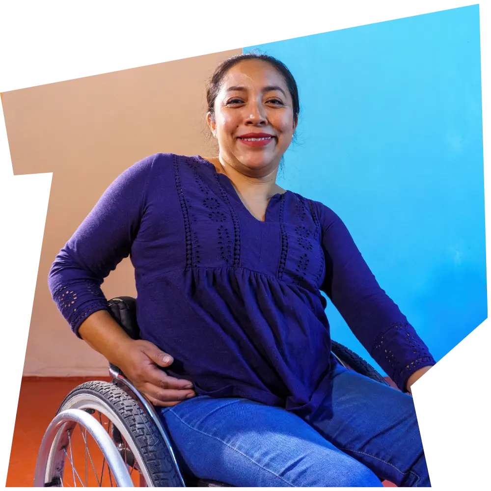 Happy disabled woman in wheelchair smiling at the camera