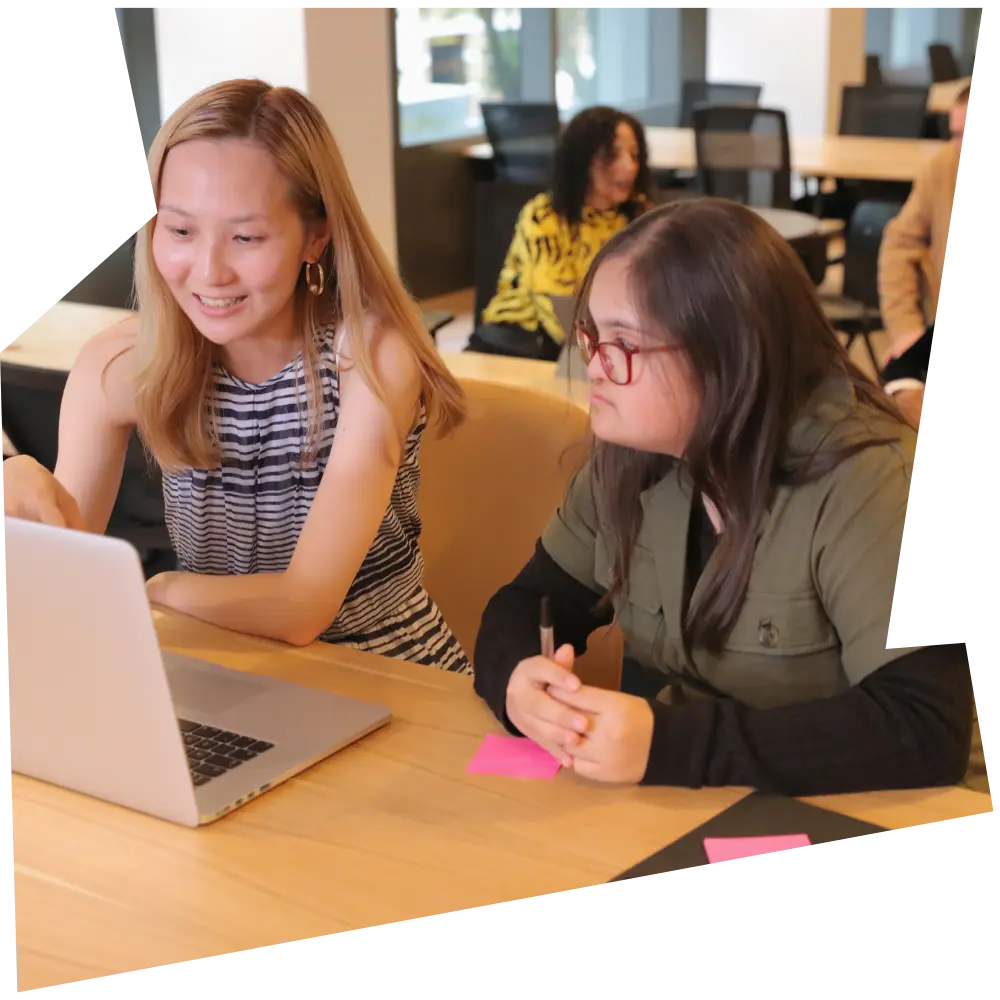 Disabled woman using using laptop with support worker